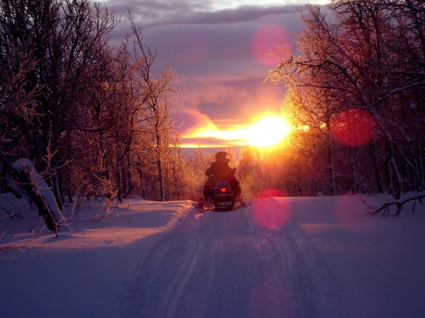 snowmobiling at sunset